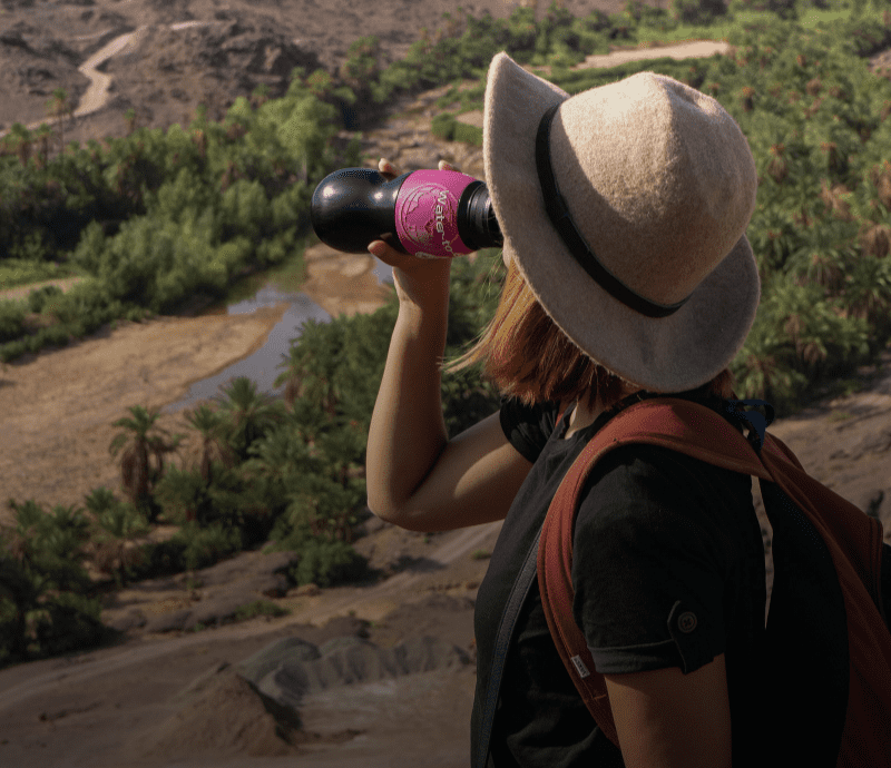 Woman drinking from water filter bottle