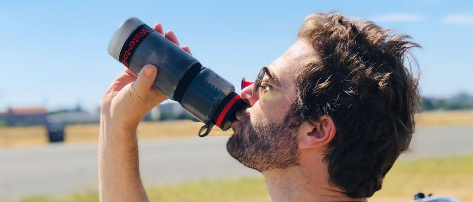 Man_in_sunglasses_drinking_from_Water_to_Go_Active_water_filter_bottle